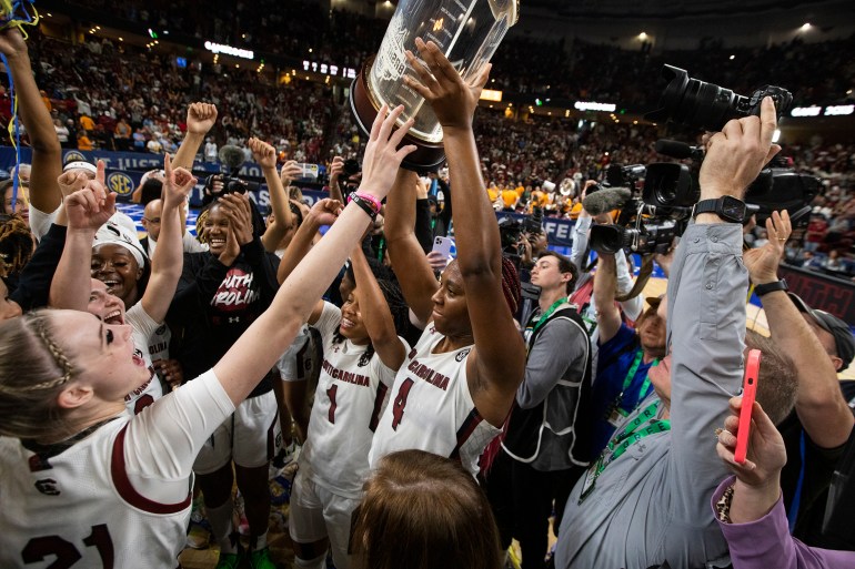 South Carolina's Aliyah Boston holds up the conference championship trophy in 2023.